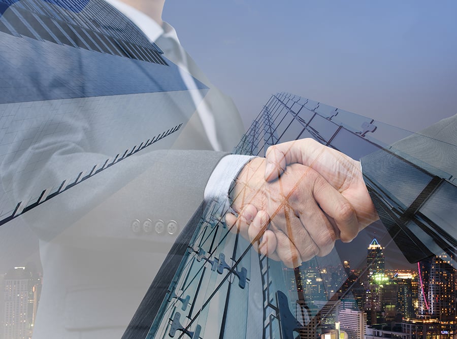 Two men shaking hands with building overlay